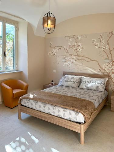 a bedroom with a bed and a wall with flowers at ABETI'S HOUSE in Rome