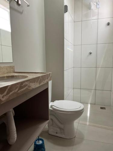 a bathroom with a toilet and a sink and a shower at Pousada Prime in Juazeiro do Norte