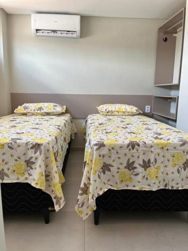 two beds sitting next to each other in a room at Pousada Prime in Juazeiro do Norte
