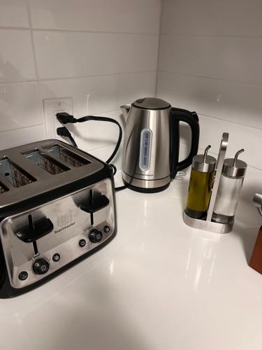 a kitchen counter with a stove and a tea kettle at Niagara Getaway across Fallsview in Niagara Falls