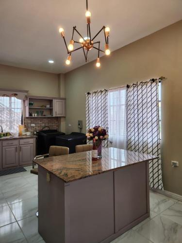 a kitchen with a large island with a counter top at Malik SuitesGY in Nismes
