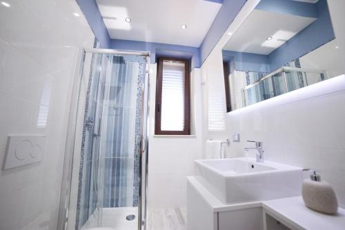 a bathroom with a glass shower and a sink at Agriturismo Nonna Rosa in Matera