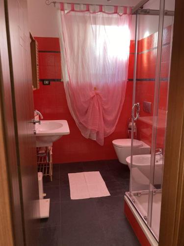 a bathroom with a sink and a toilet and a shower at La stanza dei segreti in Aosta