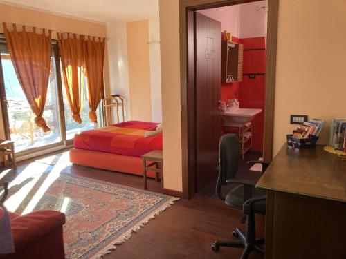 a bedroom with a bed and a desk and a chair at La stanza dei segreti in Aosta
