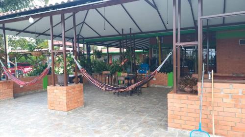 a couple of hammocks hanging outside of a building at Finca Hotel el Vergel Filandia Quindio in Filandia