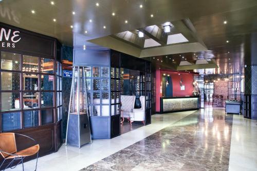 a lobby of a store with chairs and tables at Hotel Black Usaquen in Bogotá