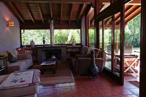 a living room with a couch and a fireplace at La Ablaneda in Soto de Cangas