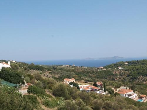 a town on a hill with the ocean in the background at Sunrise house Alonnisos in Alonnisos