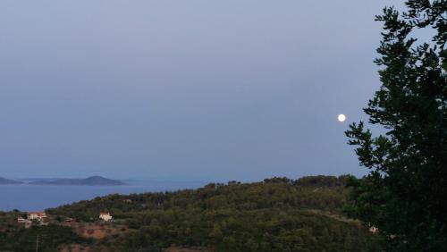 a view of a hill with the moon in the sky at Sunrise house Alonnisos in Alonnisos