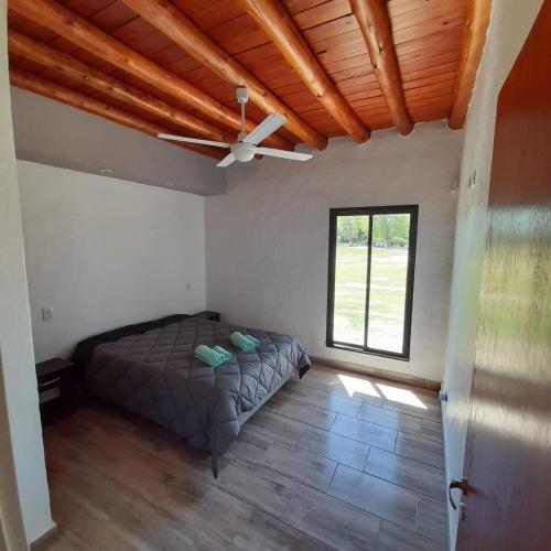 una camera da letto con un letto e un ventilatore a soffitto di VIÑAS DEL SOL a San Rafael