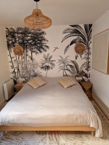 a bedroom with a bed with plants on the wall at Appartement Enghien-les-Bains à 7 min du Casino Barrière in Enghien-les-Bains