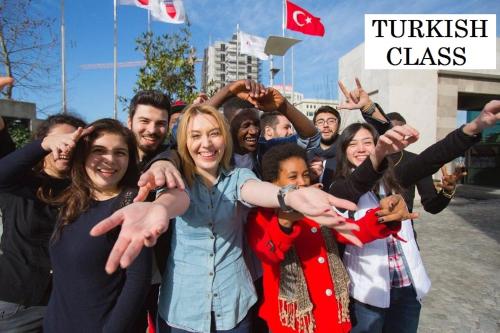 a group of people are holding their hands up at Eroz Hostel Old City in Istanbul
