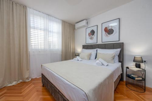 a bedroom with a large white bed with white pillows at A&M 3 BRIDGE Luxury Center in Zadar