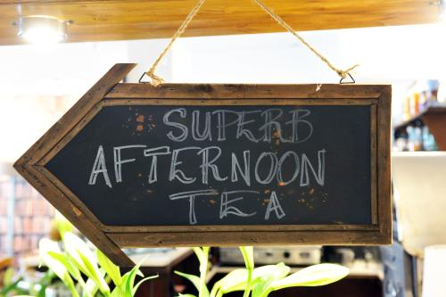 a sign that reads super afternoon tea in a store at The Kings Arms Hotel in Berwick-Upon-Tweed