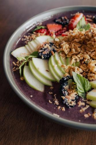 a plate of food with fruit and nuts on a table at Sunrock Hotel & Suites in Cabo San Lucas