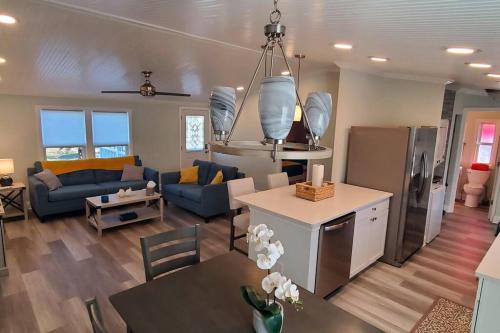 a kitchen and living room with a couch and a table at Waterfront home with private dock, walk to beach in Saint Augustine