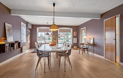 a dining room with a table and chairs at Nice Home In Bredebro With Wifi in Bredebro