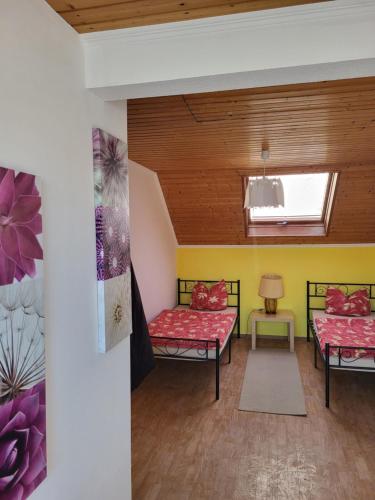 a living room with two beds and a window at Gemeinschaft Ferienhaus in Bad Neuenahr-Ahrweiler