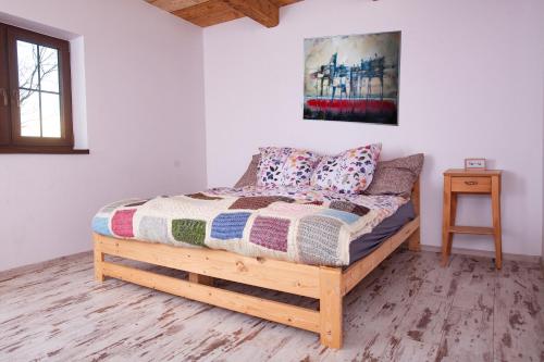 um quarto com uma cama de madeira com almofadas em Na Chałupki 