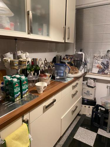 a kitchen with a counter top with lots of clutter at 2,5zi Wohnung mit Loggia 78m2 Munich/München in Munich