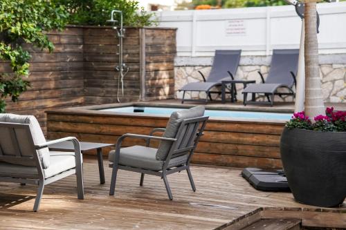 a patio with chairs and a swimming pool at Rosen Villa at Ramat Hahayal in Tel Aviv