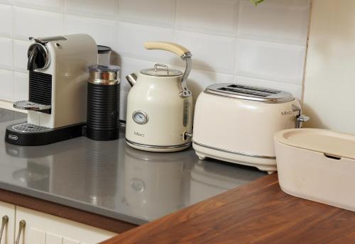 a kitchen counter with two toasters and a toaster at Rosen Villa at Ramat Hahayal in Tel Aviv