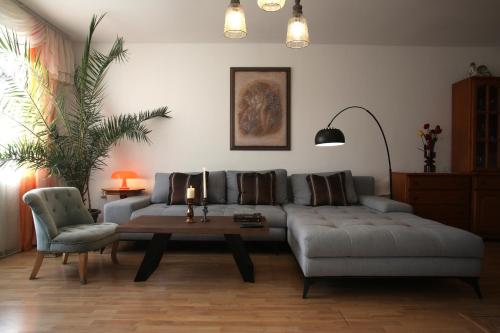 a living room with a couch and a table at Private summer villa close to the black sea in Nesebar