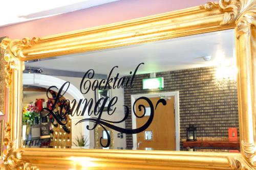 a mirror with the words graceful sunrise written on it at The Kings Arms Hotel in Berwick-Upon-Tweed