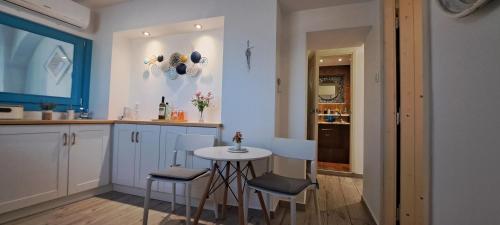 a kitchen with a small table and chairs in it at Final step in Skiathos Town