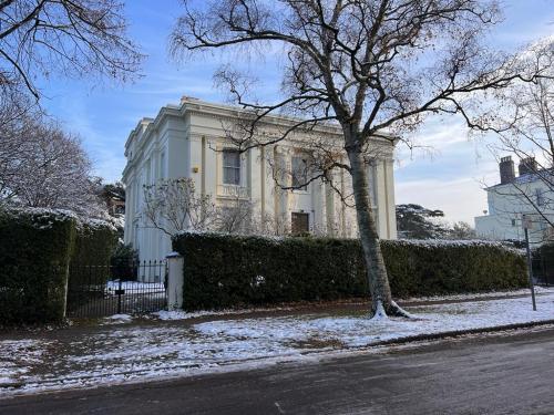 a white house with a tree in the snow at RRM Studio 