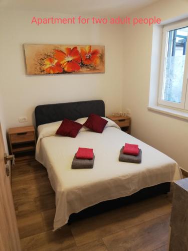 a bedroom with a bed with two pillows on it at Apartments SEEA in Izola