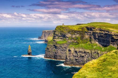 a large cliff in the ocean next to the ocean at Coastal View House in Doolin