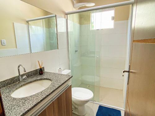 a bathroom with a toilet and a sink and a shower at Condomínio Lençóis Ville Residence in Barreirinhas