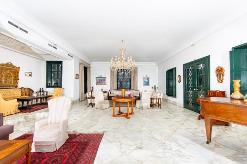 a living room filled with furniture and a piano at Arabesque House in La Marsa