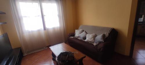 a living room with a couch and a window at Casa Kiara in Santa Cruz de la Palma