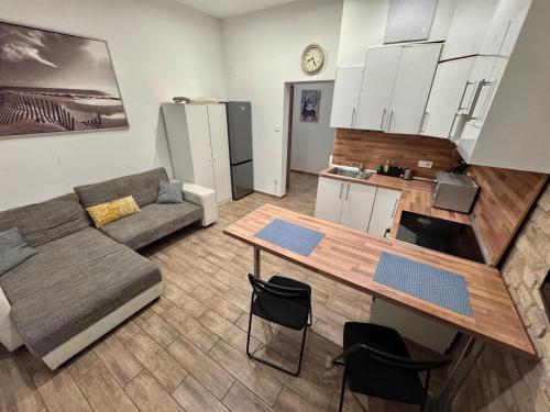 a living room with a couch and a table at S6 - APARTMENT PROMO next to gozsdu garden in Budapest