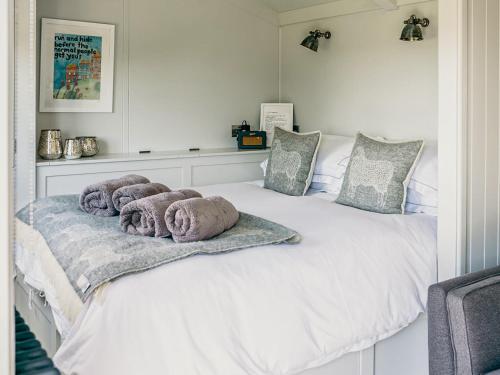 a bedroom with a bed with towels on it at Coopy Corner-uk36583 in Milton Abbot