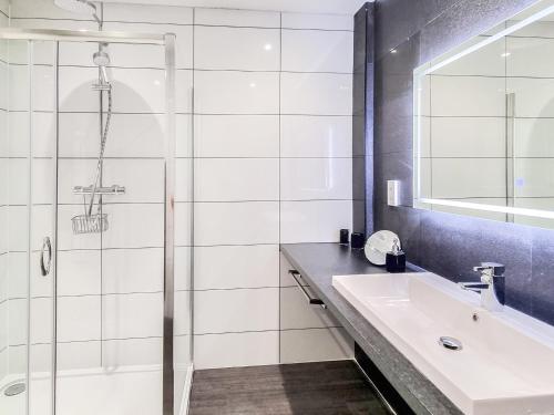 a bathroom with a sink and a shower at Belvedere in Corfe Mullen