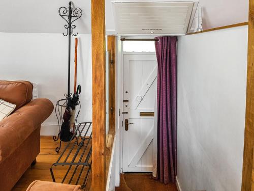 a living room with a door and a couch at Craigdarroch Cottage in Saint Fillans