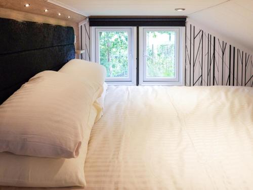 a white bed in a room with a window at Forest Escape - Uk7813 in Coirantee