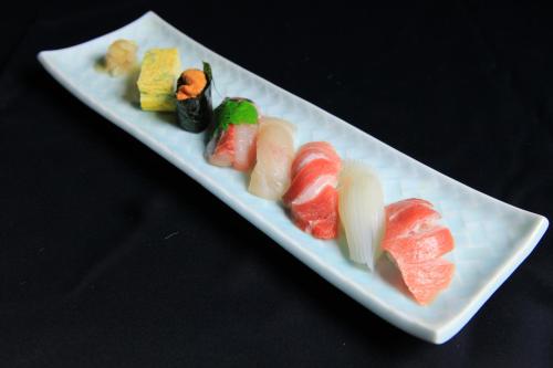 a white plate with different types of food on it at Daitokuji Sushicho in Kyoto