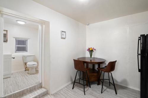 a bathroom with a table and chairs and a toilet at Studio Casita-15 min walk to Downtown Plaza in Santa Fe