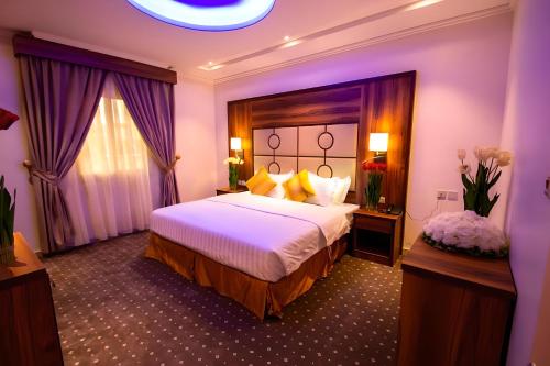 pokój hotelowy z dużym łóżkiem i oknem w obiekcie Hayat Al Rose Hotel Appartment w mieście Dżudda