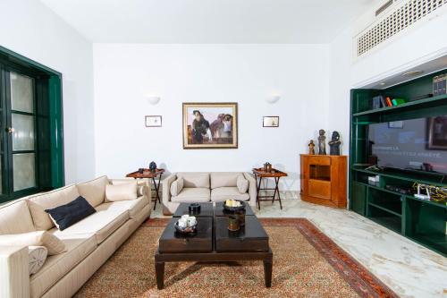 a living room with a couch and a coffee table at Arabesque House in La Marsa