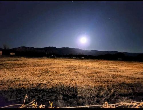 a large field with the moon in the sky at Luna de Cafayate Hotel Boutique in Cafayate