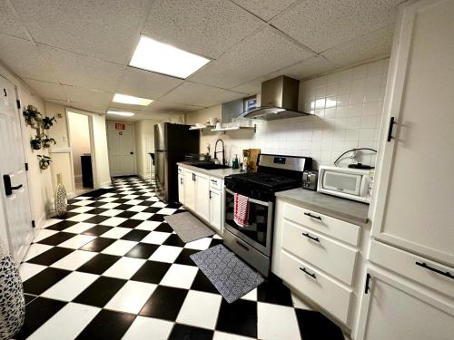 a kitchen with a black and white checkered floor at 4-A Diamond in Yonkers in Yonkers