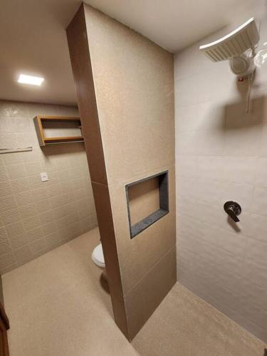a bathroom with a shower with a toilet in it at Apartamentos da Rota in Domingos Martins