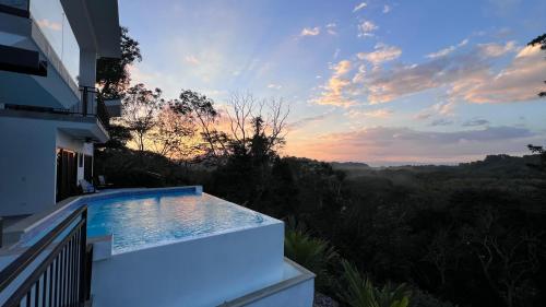a swimming pool on the side of a house at Vida Palace in Jacó