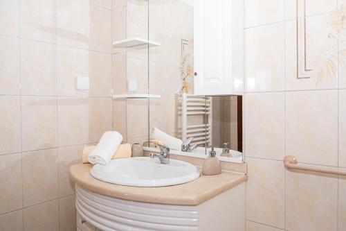 a bathroom with a sink and a mirror at Ponta do Sol hills view 2BR in Ponta do Sol