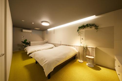 a bedroom with a bed and a large mirror at Holiday House Green Garden in Gujo